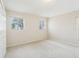 Spacious bedroom with neutral carpet, two windows, and a double door closet at 10211 Quails Landing Ave, Tampa, FL 33647