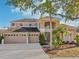 Stunning two-story home showcasing manicured landscaping and a three-car garage at 10211 Quails Landing Ave, Tampa, FL 33647