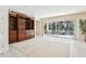 Spacious living room featuring tiled floors, built-in shelving, and a sliding glass door for seamless indoor-outdoor living at 10211 Quails Landing Ave, Tampa, FL 33647