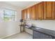 Home office featuring built in cabinetry, a large window and neutral carpeting at 10211 Quails Landing Ave, Tampa, FL 33647