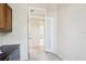 Hallway view of the home office and a full bathroom featuring neutral paint at 10211 Quails Landing Ave, Tampa, FL 33647