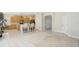 Bright, open floorplan with tiled floors connecting the kitchen and dining area at 10211 Quails Landing Ave, Tampa, FL 33647
