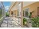 Covered outdoor space with brick flooring, large windows, and access to an outdoor kitchen at 10211 Quails Landing Ave, Tampa, FL 33647
