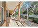 Screened-in lanai overlooking a lake featuring tile floor and outdoor lighting at 10211 Quails Landing Ave, Tampa, FL 33647