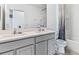 Bright bathroom with double sinks, a large mirror, and modern fixtures at 10605 Dusty Boot Rd, Land O Lakes, FL 34638