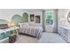 Cozy bedroom featuring a stylish accent wall, carpeted floor, and a large window at 10605 Dusty Boot Rd, Land O Lakes, FL 34638