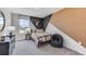 Comfortable bedroom featuring a stylish accent wall, carpeted floor, and a bright window at 10605 Dusty Boot Rd, Land O Lakes, FL 34638