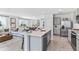 Open-concept kitchen featuring stainless steel appliances, a large island, and bar stool seating at 10605 Dusty Boot Rd, Land O Lakes, FL 34638