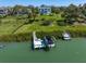 An aerial view shows a house on the water, boat lifts, and a dock at 110 Harbor View Ln, Belleair Bluffs, FL 33770