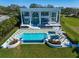 Aerial view of an estate showcasing a pool and spacious outdoor lounge areas for relaxing or entertaining at 110 Harbor View Ln, Belleair Bluffs, FL 33770