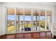 Stunning outdoor views from the living room balcony show the backyard, pool, and waterway at 110 Harbor View Ln, Belleair Bluffs, FL 33770