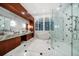 Elegant bathroom with a soaking tub, double sinks, and walk-in shower at 110 Harbor View Ln, Belleair Bluffs, FL 33770