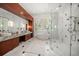 Luxurious bathroom with marble finishes, a freestanding tub, dual sinks, and a glass-enclosed shower at 110 Harbor View Ln, Belleair Bluffs, FL 33770