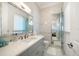 Bathroom featuring neutral paint, gray vanity, chrome fixtures, a white toilet, and a glass shower at 110 Harbor View Ln, Belleair Bluffs, FL 33770