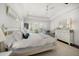 Cozy bedroom with white furnishings, plush bedding, and natural light from shuttered windows at 110 Harbor View Ln, Belleair Bluffs, FL 33770