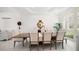 Formal dining room with a large wood table, decorative mirror, and arched window at 110 Harbor View Ln, Belleair Bluffs, FL 33770