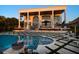 Stunning waterfront property with a large pool, covered patio, and lush tropical landscaping at 110 Harbor View Ln, Belleair Bluffs, FL 33770