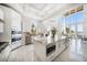 Gourmet kitchen with marble counters, stainless appliances, and abundant natural light at 110 Harbor View Ln, Belleair Bluffs, FL 33770