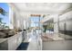 Bright, modern kitchen with marble counters, stainless steel appliances, and expansive windows offering water views at 110 Harbor View Ln, Belleair Bluffs, FL 33770