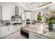 Modern kitchen featuring marble countertops, stainless steel appliances, and designer finishes at 110 Harbor View Ln, Belleair Bluffs, FL 33770