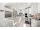 Modern kitchen features a marble island, custom cabinetry, and stainless steel appliances at 110 Harbor View Ln, Belleair Bluffs, FL 33770
