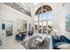 Spacious living room featuring high ceilings, marble floors, and water views at 110 Harbor View Ln, Belleair Bluffs, FL 33770