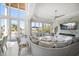 Bright and spacious living room featuring a fireplace, soaring ceilings, and panoramic water views at 110 Harbor View Ln, Belleair Bluffs, FL 33770