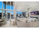Spacious living room with marble floors, floor-to-ceiling windows, fireplace, and comfortable seating at 110 Harbor View Ln, Belleair Bluffs, FL 33770