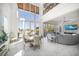 Open-concept living room boasts soaring ceilings, expansive windows, and a waterfront view at 110 Harbor View Ln, Belleair Bluffs, FL 33770