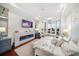 Bright main bedroom features hardwood floors, fireplace, water view and seating area at 110 Harbor View Ln, Belleair Bluffs, FL 33770