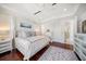 Bright main bedroom features a white tray ceiling, hardwood floors, and a cozy rug for added comfort at 110 Harbor View Ln, Belleair Bluffs, FL 33770
