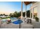 A patio with a pool, spa, and fire bowls provides a luxurious outdoor living space with comfortable seating at 110 Harbor View Ln, Belleair Bluffs, FL 33770