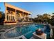 Luxury home featuring a stunning pool, fire pit, and elegant architecture at 110 Harbor View Ln, Belleair Bluffs, FL 33770
