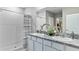Modern bathroom with dual sinks, granite countertops, decorative mirrors and a spacious walk-in shower at 11091 Cotton Vale Pl, San Antonio, FL 33576