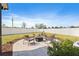 Serene backyard with a paved patio, fire pit, seating, and well-maintained landscaping at 11403 Alachua Creek Ln, Riverview, FL 33579