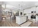 Open-concept kitchen and living area featuring stainless steel appliances and hardwood floors at 11403 Alachua Creek Ln, Riverview, FL 33579