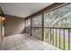 Screened balcony with views of trees and a sidewalk at 12025 Environmental Dr # 5, New Port Richey, FL 34654