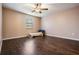 Bedroom with wood floors, fan, and natural light from window at 12025 Environmental Dr # 5, New Port Richey, FL 34654
