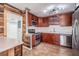 Stylish kitchen features stainless appliances, wood cabinets, and unique wood accents at 12025 Environmental Dr # 5, New Port Richey, FL 34654