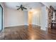 Living room with hardwood floors, fan and access to kitchen and balcony at 12025 Environmental Dr # 5, New Port Richey, FL 34654