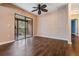 Living room with ceiling fan, wood floors, and sliding doors to balcony at 12025 Environmental Dr # 5, New Port Richey, FL 34654