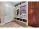 Cozy mud room with storage, bench, and natural light streaming through the window at 12025 Environmental Dr # 5, New Port Richey, FL 34654