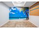 Bright room features a beach-themed mural, light tile floors, and natural light at 12025 Environmental Dr # 5, New Port Richey, FL 34654
