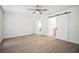 Spacious bedroom with modern features including a sliding barn door to bathroom and modern ceiling fan at 1218 Lornewood Dr, Valrico, FL 33596
