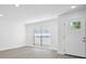 Freshly painted room with a window and a front door with glass accents to let the light stream in at 1218 Lornewood Dr, Valrico, FL 33596