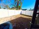 Spacious backyard with a white fence and mature trees, offering privacy and space for outdoor activities at 15013 Redcliff Dr, Tampa, FL 33625