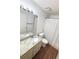 Bathroom featuring a granite countertop vanity, toilet and shower with curtain and wood-look flooring at 15013 Redcliff Dr, Tampa, FL 33625
