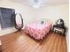 Cozy bedroom with a floral-themed bed and a decorative mirror and vanity table at 15013 Redcliff Dr, Tampa, FL 33625