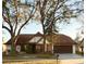 Charming two-story home with a well-maintained front yard and mature trees at 15013 Redcliff Dr, Tampa, FL 33625