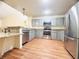 Well-lit kitchen boasts modern stainless-steel appliances and sleek gray cabinets with ample counter space at 15013 Redcliff Dr, Tampa, FL 33625